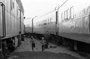 train photo with children running by John Gruber