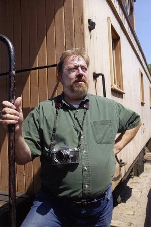 portrait of John Gruber with camera